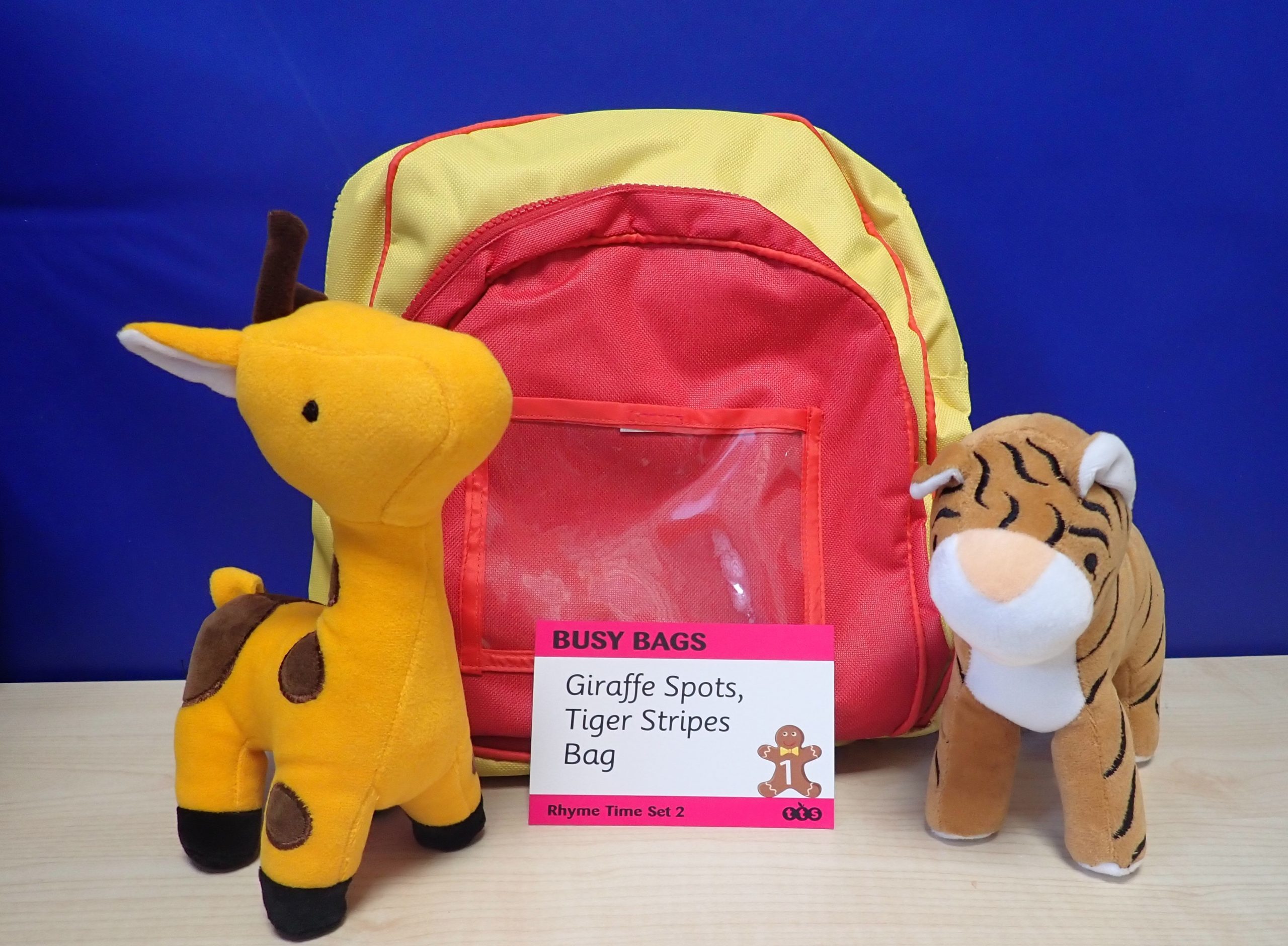 Rhyme time bag – Giraffe spots, tiger stripes. Yellow and red backpack with 2 soft toys: a giraffe and a tiger.