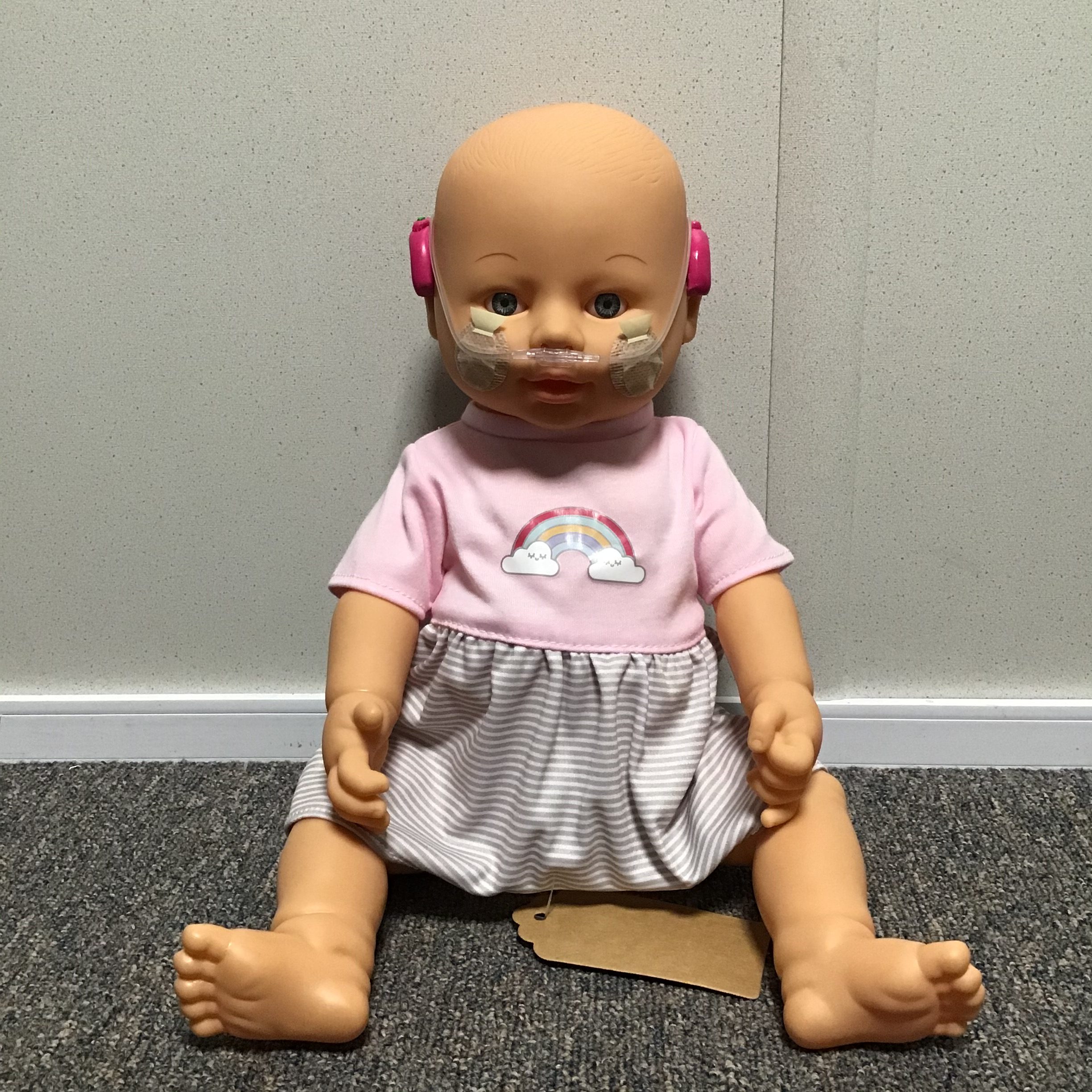 Doll toy with hearing aids and a nasogastric tube